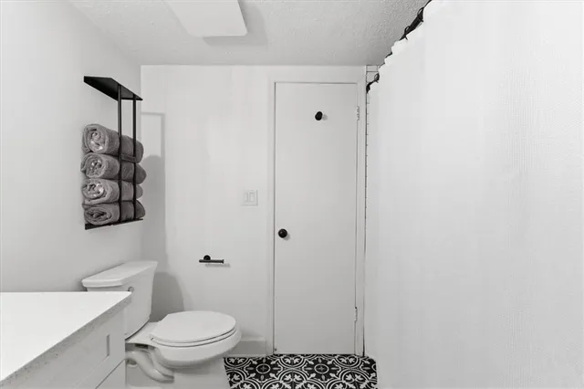 a bathroom with a toilet and a shower