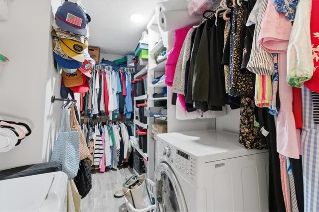 a view of walk in closet with clothes