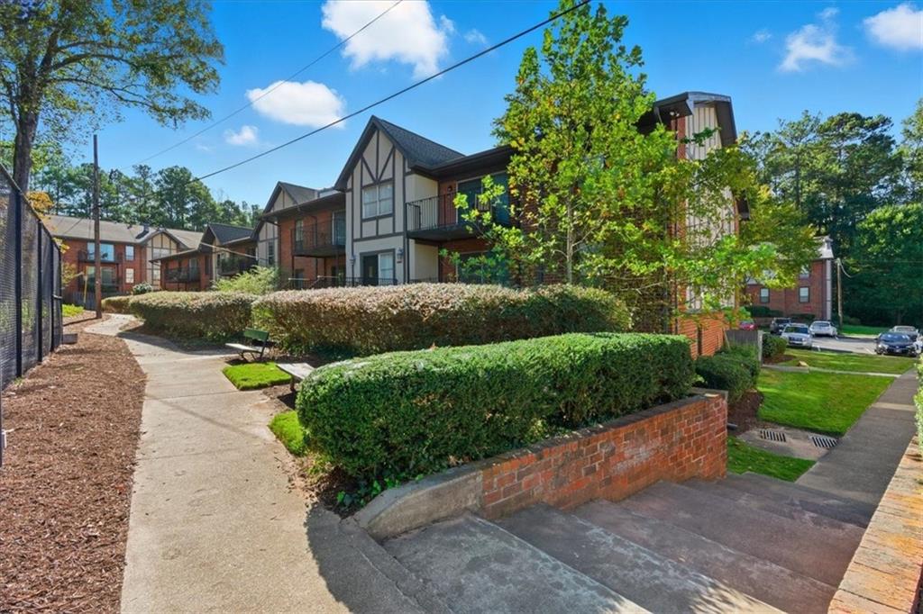 6851 Roswell Road, Unit J14 Sandy Springs, GA 30328 - Photo 22 of 41 a view of a garden with a house