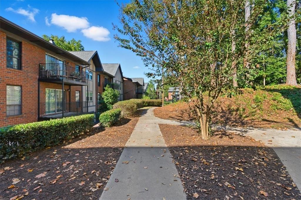 6851 Roswell Road, Unit J14 Sandy Springs, GA 30328 - Photo 24 of 41 a view of a yard in front of a house