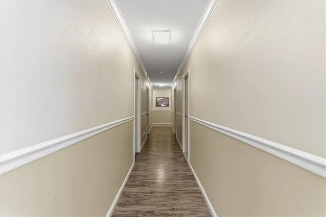 a view of a room with wooden floor and a window