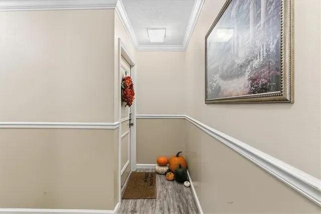 a view of a brick house with a small yard and wooden fence