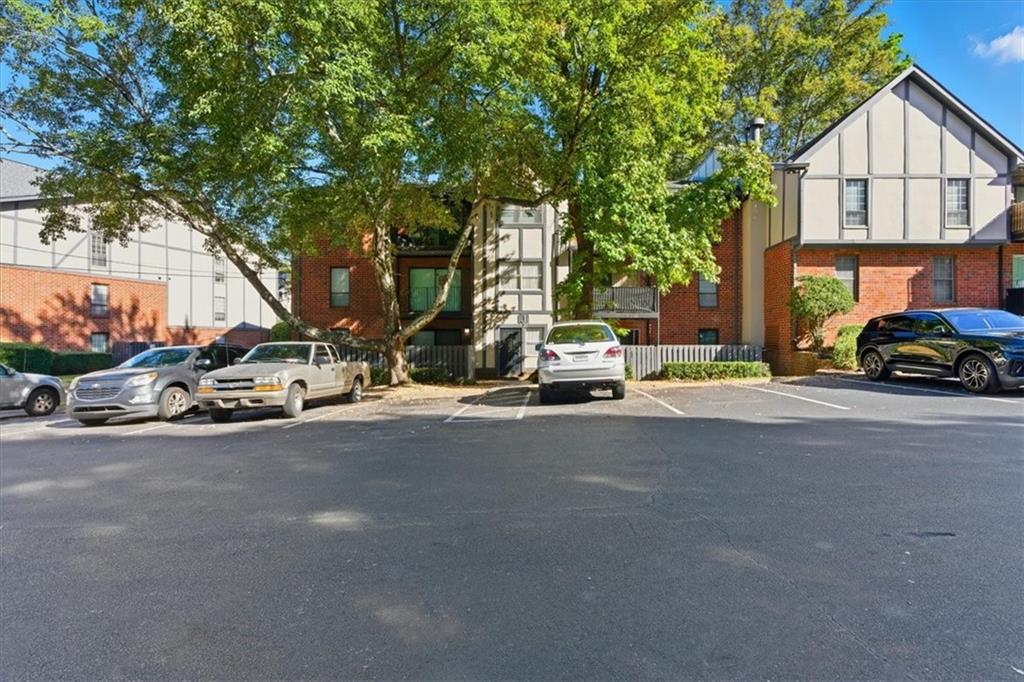 6851 Roswell Road, Unit J14 Sandy Springs, GA 30328 - Photo 38 of 41 a view of a street with a car parked on the road