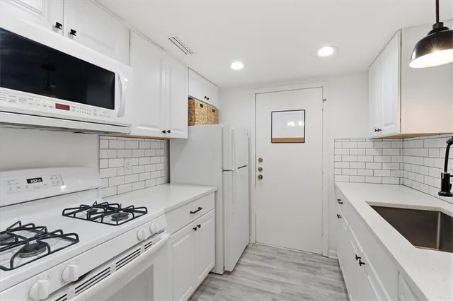 a kitchen with a stove and a microwave