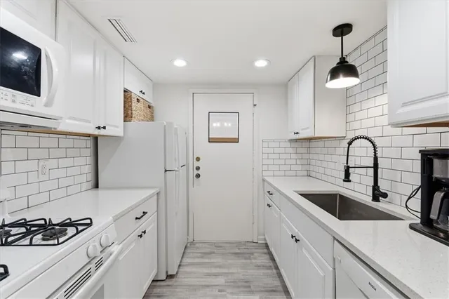 a kitchen with a sink and cabinets