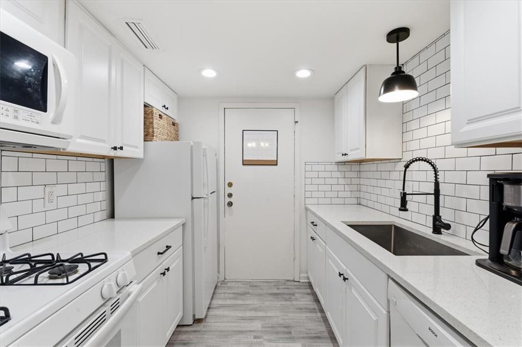 6851 Roswell Road, Unit J14 Sandy Springs, GA 30328 - Photo 6 of 41 a kitchen with a sink and cabinets
