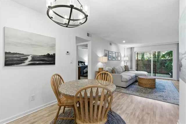 a dining room with furniture a window and a chandelier
