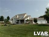 895 Gove Road Nazareth, PA 18064 - Photo 12 of 66 a front view of a house with a yard table and chairs