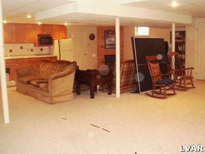 895 Gove Road Nazareth, PA 18064 - Photo 57 of 66 a living room with furniture a flat screen tv and gym equipment