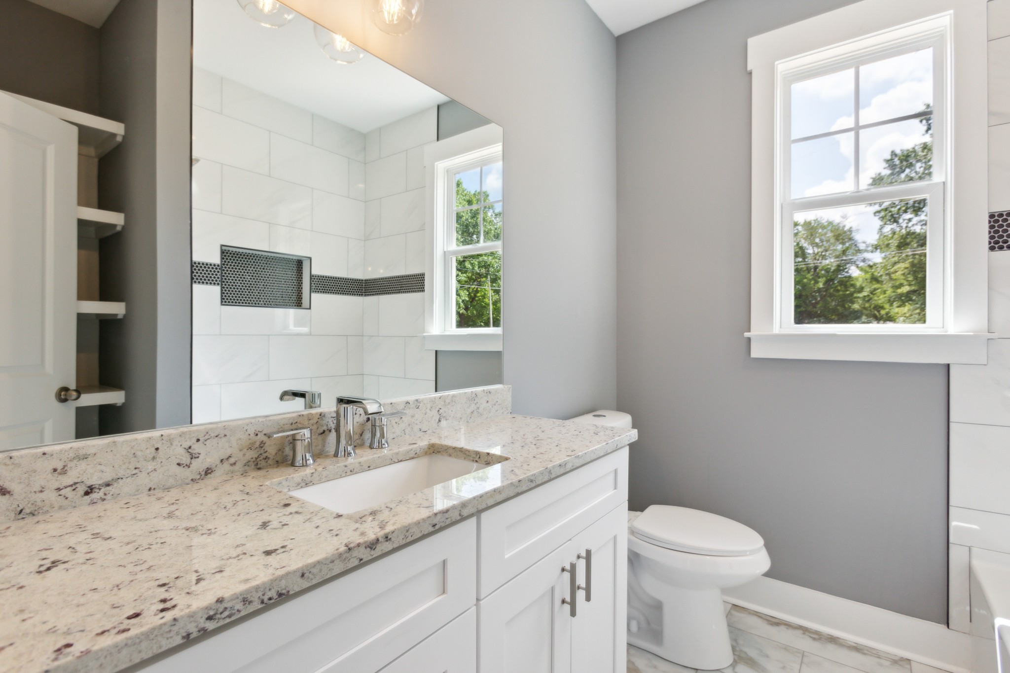 618 Scattersville Road Portland, TN 37148 - Photo 13 of 18 a bathroom with a granite countertop toilet a sink and a window