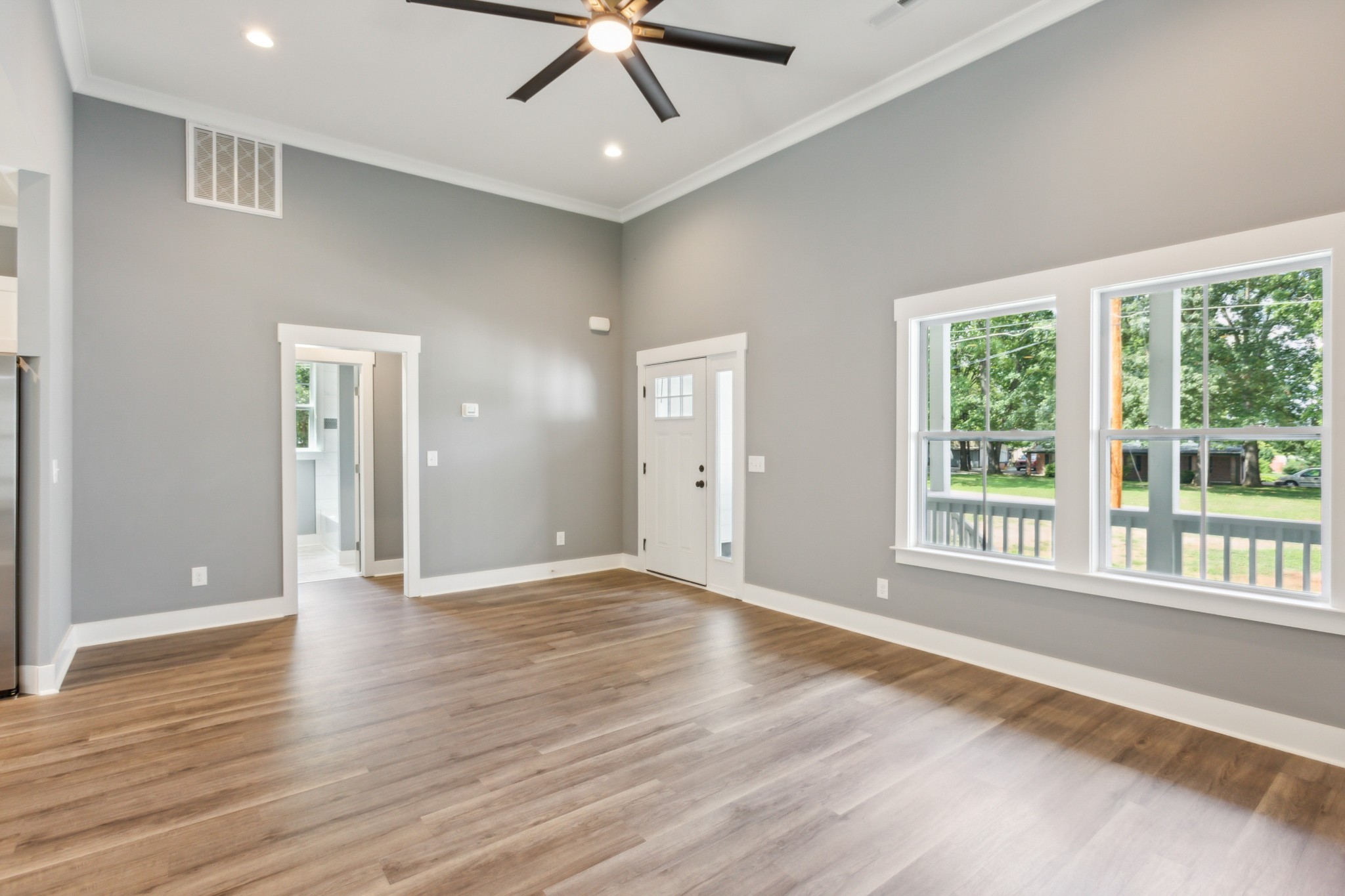 618 Scattersville Road Portland, TN 37148 - Photo 4 of 18 a view of an empty room with a window and wooden floor