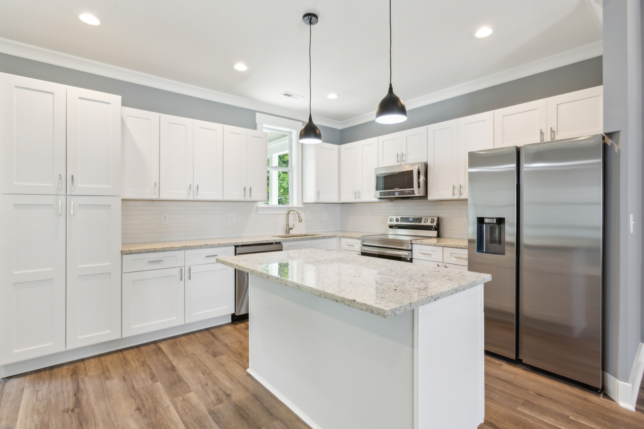 618 Scattersville Road Portland, TN 37148 - Photo 7 of 18 a kitchen with stainless steel appliances granite countertop a refrigerator a sink dishwasher a stove and white cabinets with wooden floor