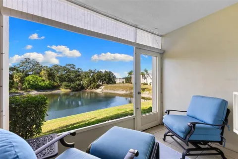 a living room with couch floor to ceiling window and a floor to ceiling window