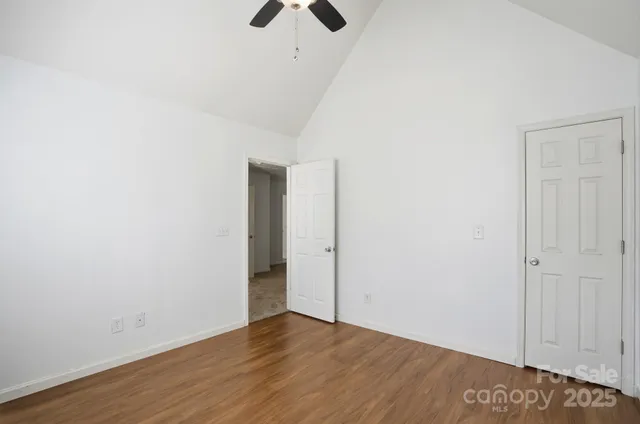 a view of a house with a small yard and wooden floor and fence