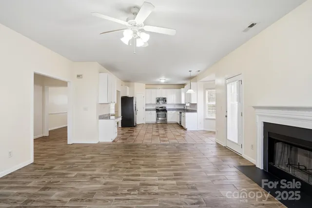 a view of a kitchen with a sink and a refrigerator