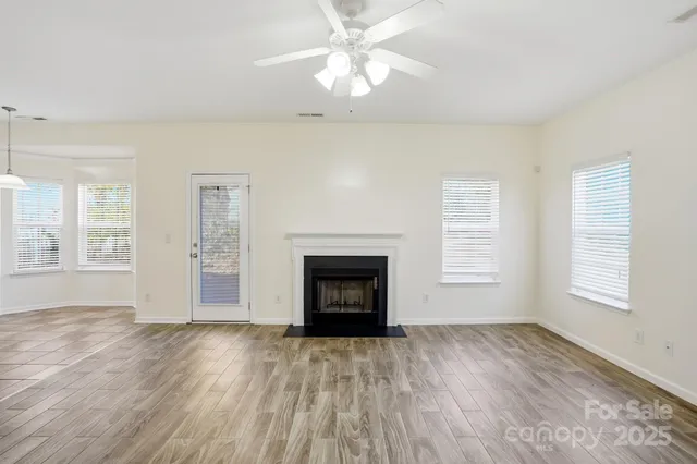 a kitchen with stainless steel appliances granite countertop a refrigerator a sink dishwasher a stove with white cabinets and countertops