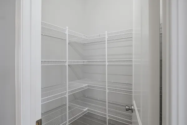 a view of walk in closet with empty racks
