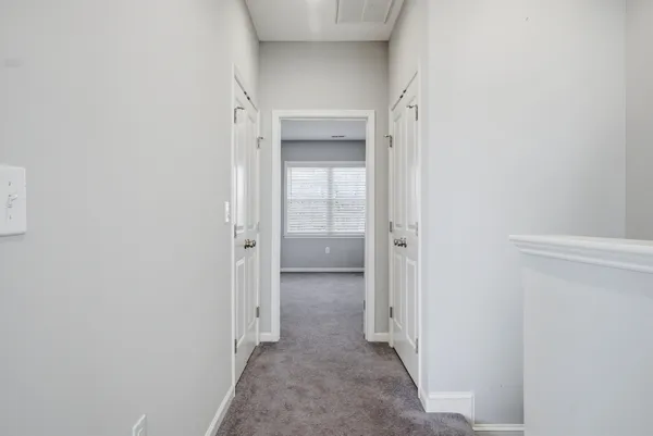 a view of a hallway with wooden shelves