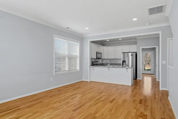 a view of a kitchen with wooden floor