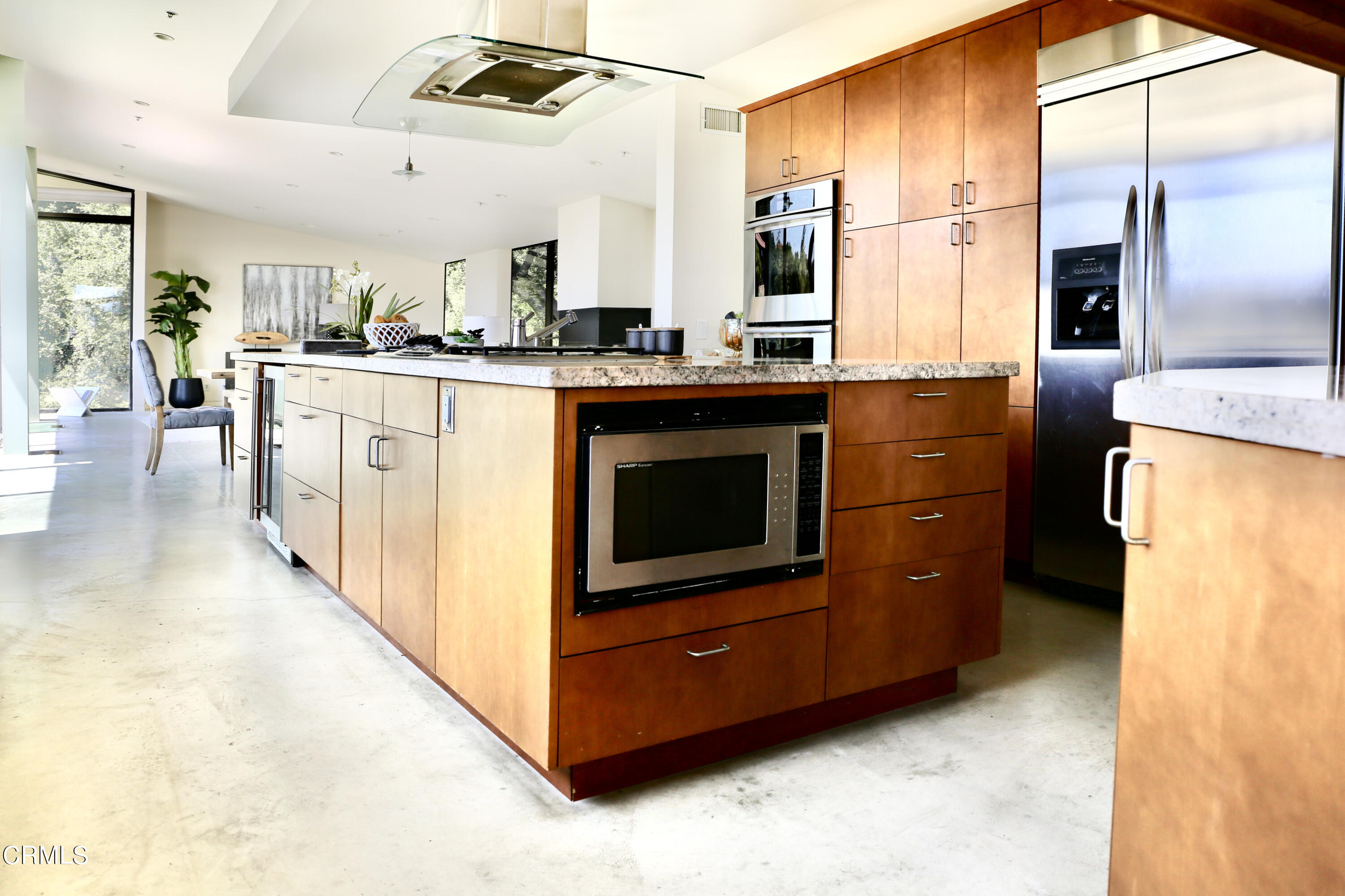 3555 Shaw Ranch Road Pasadena, CA 91107 - Photo 13 of 45 a kitchen with stainless steel appliances kitchen island granite countertop a refrigerator a stove and a sink with large cabinets