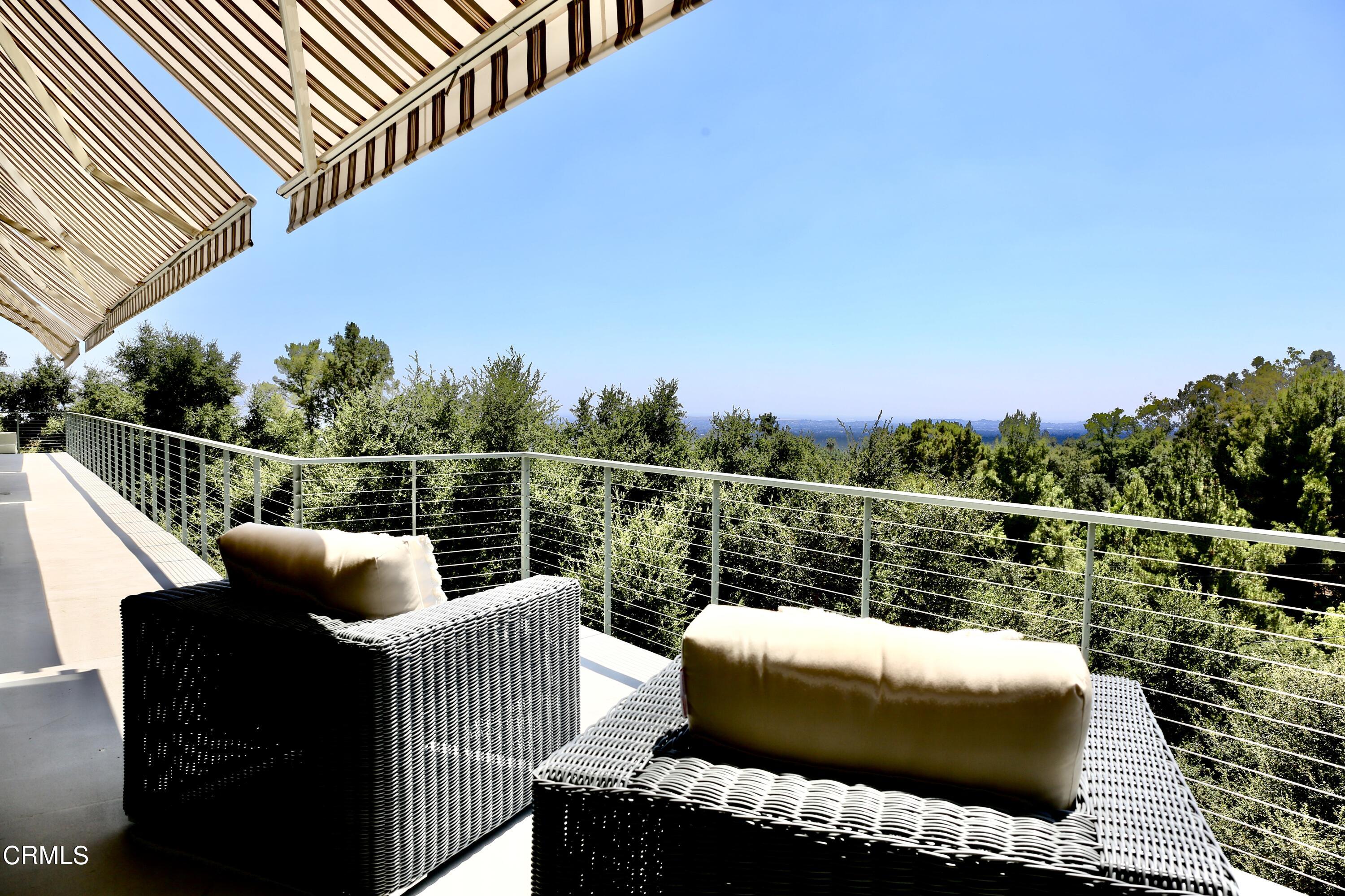 3555 Shaw Ranch Road Pasadena, CA 91107 - Photo 23 of 45 a balcony with wooden floor and outdoor seating