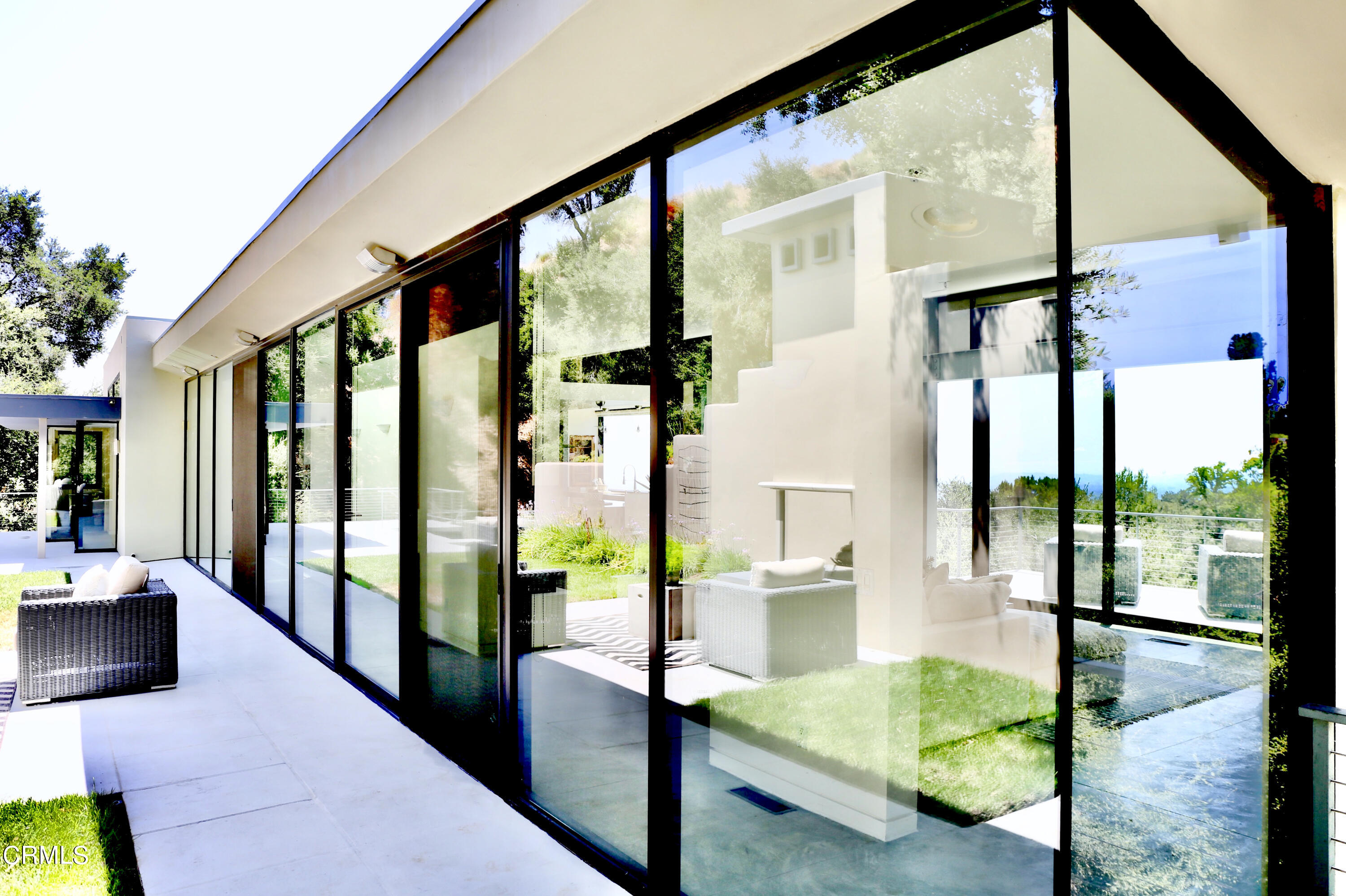 3555 Shaw Ranch Road Pasadena, CA 91107 - Photo 4 of 45 a living room with large glass windows and table