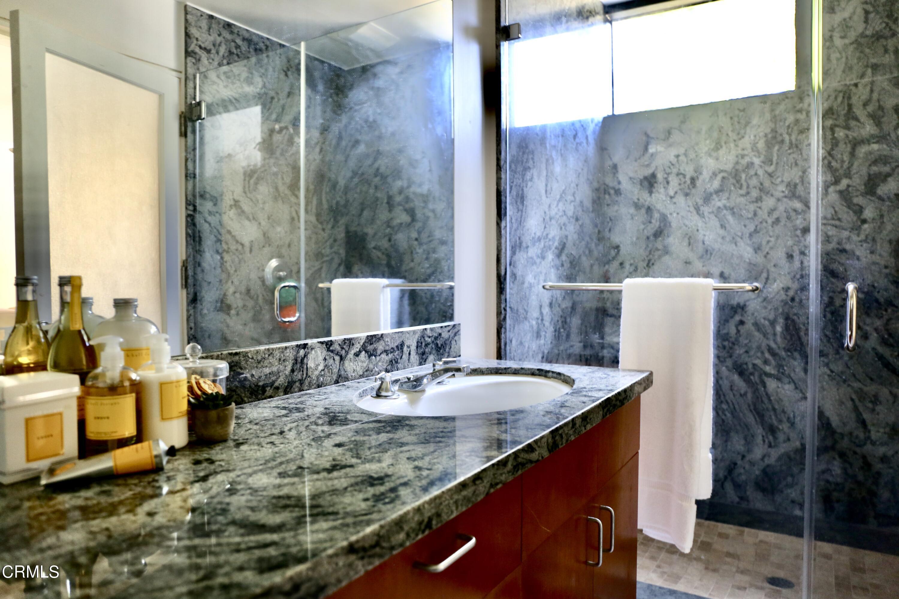 3555 Shaw Ranch Road Pasadena, CA 91107 - Photo 41 of 45 a bathroom with a granite countertop sink and a mirror