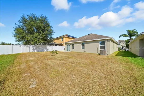 a view of a house with a backyard