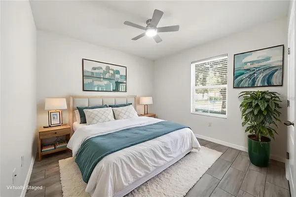 a bedroom with a large bed and a painting on the wall