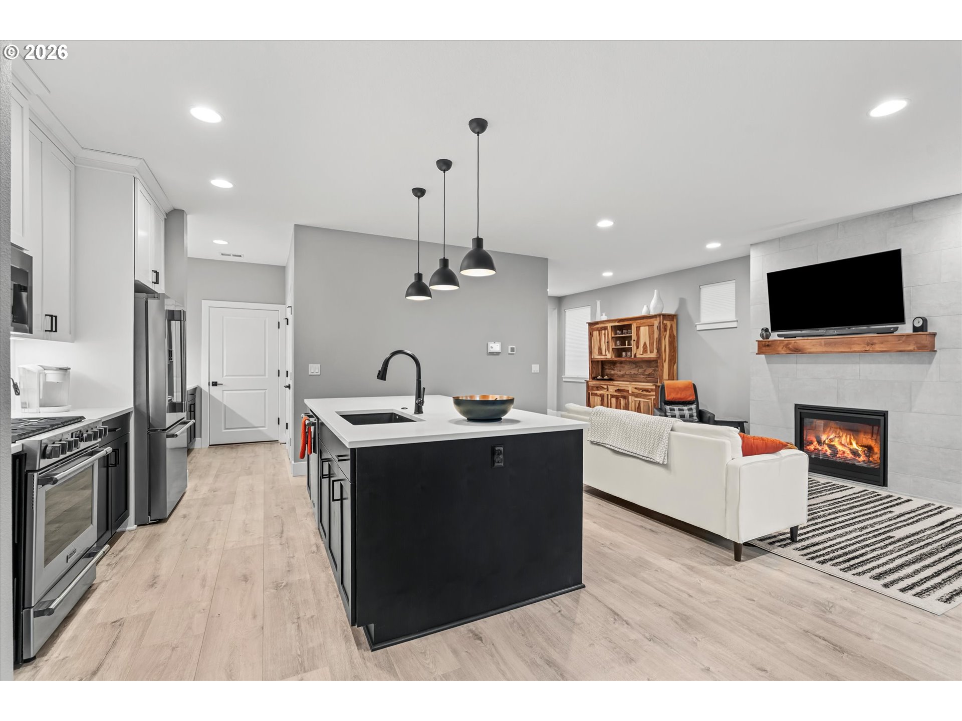 723 Southwest 49th Street Gresham, OR 97080 - Photo 12 of 48 a living room with furniture a fireplace and a flat screen tv