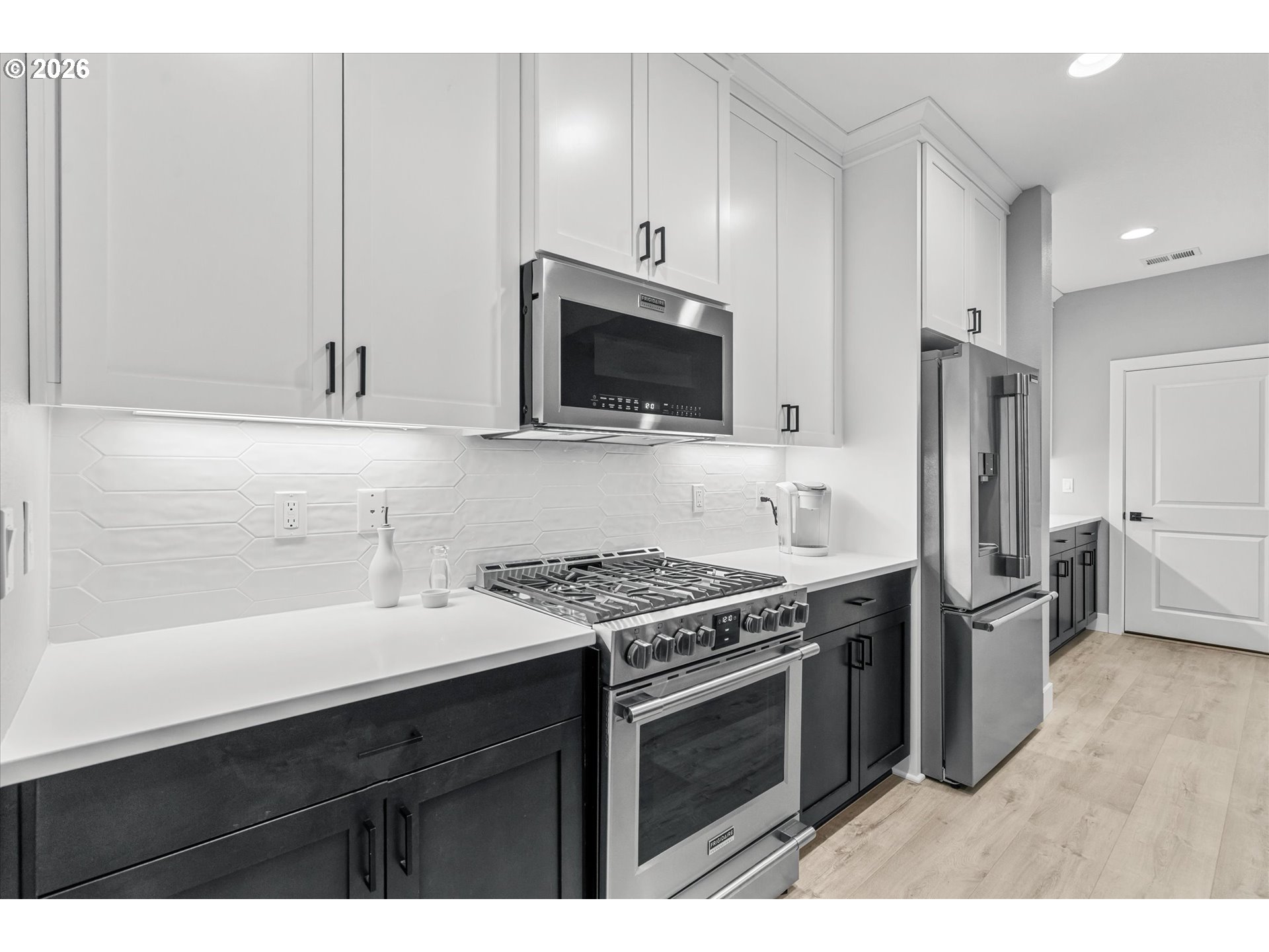 723 Southwest 49th Street Gresham, OR 97080 - Photo 14 of 48 a kitchen with stainless steel appliances a stove a sink and a microwave