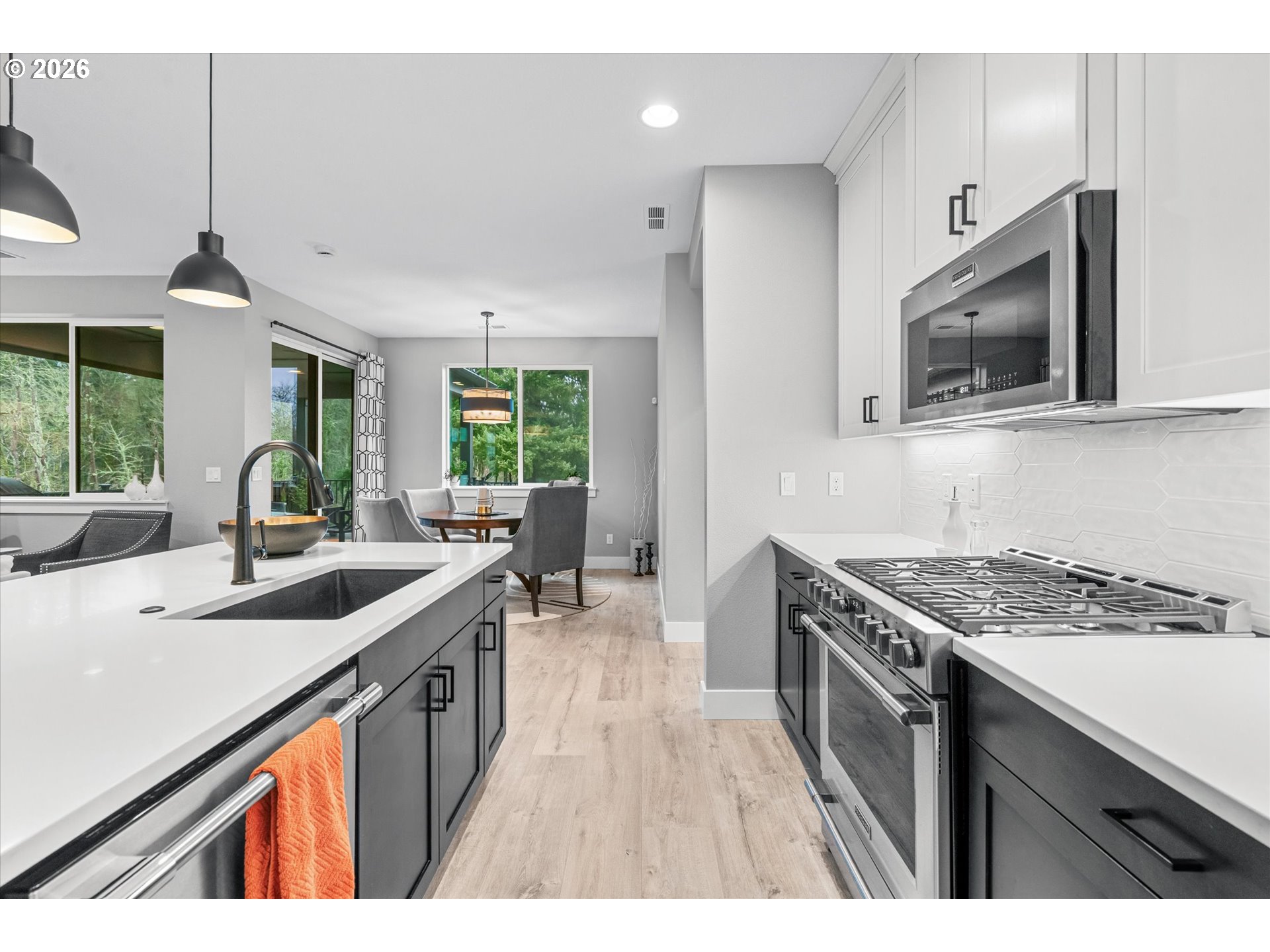 723 Southwest 49th Street Gresham, OR 97080 - Photo 16 of 48 a kitchen with stainless steel appliances granite countertop a sink stove and cabinets