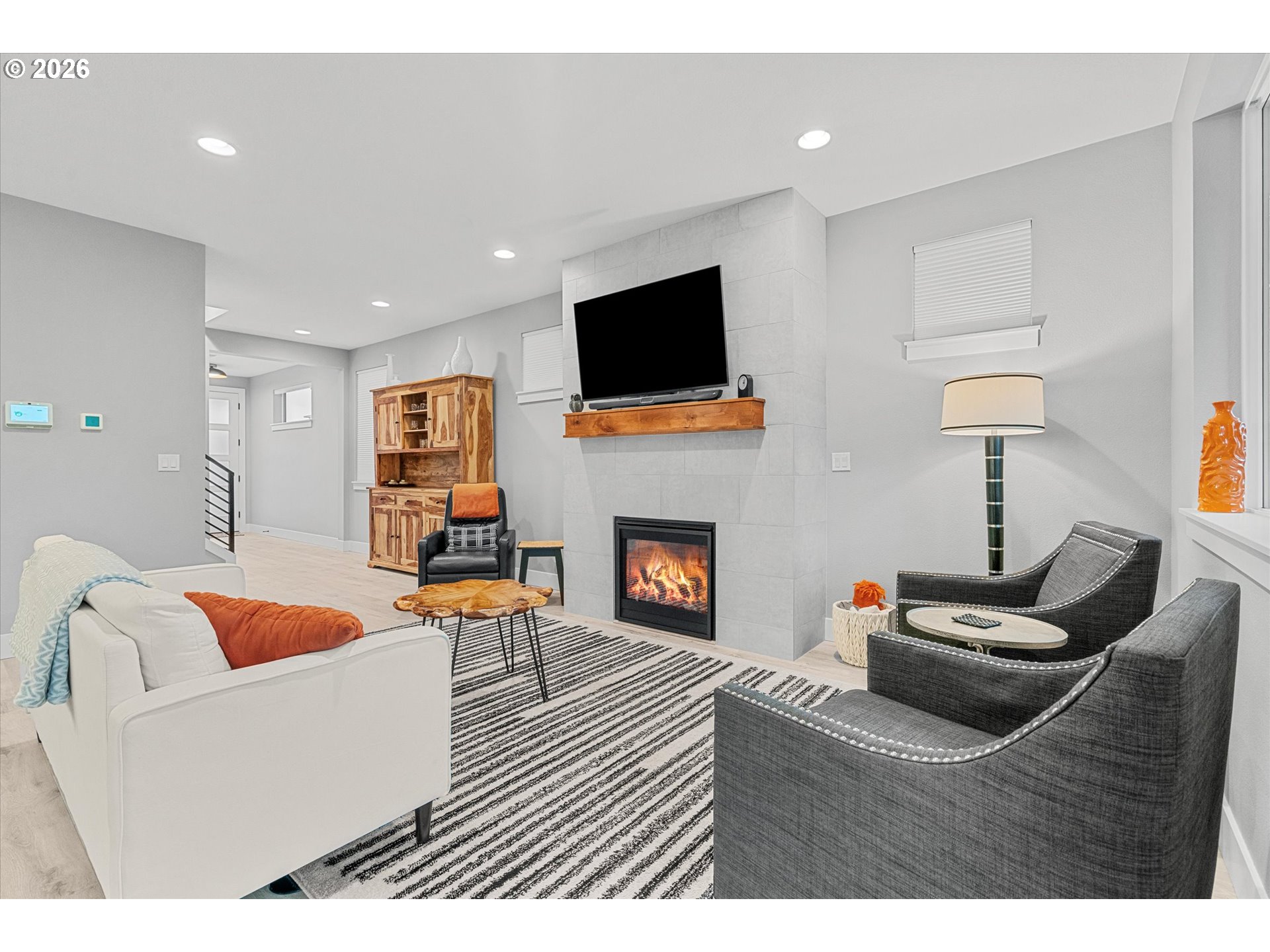 723 Southwest 49th Street Gresham, OR 97080 - Photo 9 of 48 a living room with furniture a flat screen tv and a fireplace