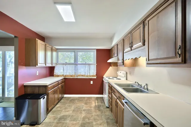 a kitchen with stainless steel appliances granite countertop a stove sink and cabinets