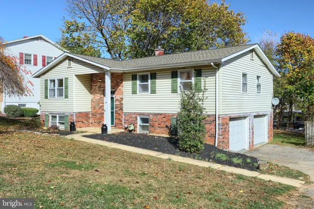 a view of a house with a yard and lawn chairs