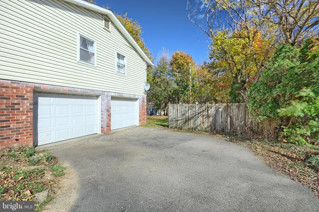 a view of a house with a garage and balcony