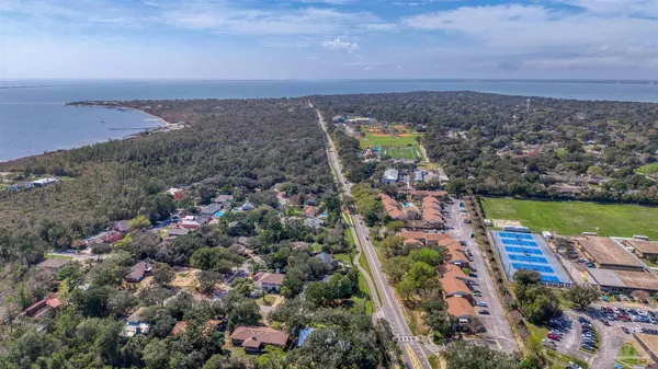 an aerial view of a house with a lake view