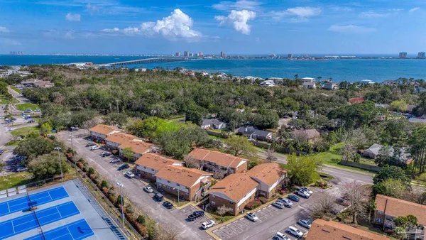 an aerial view of residential houses with outdoor space