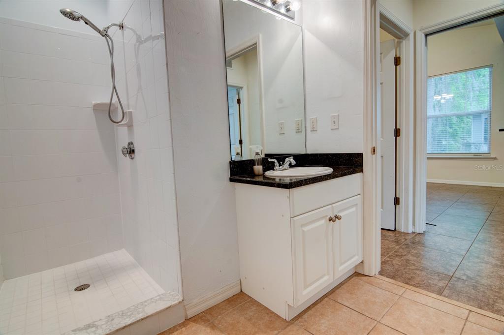 1563 Northwest 29 Road, Unit 108 Gainesville, FL 32605 - Photo 12 of 25 a bathroom with a sink and a mirror