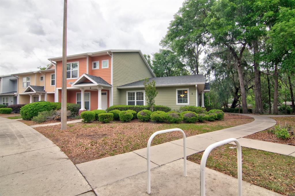1563 Northwest 29 Road, Unit 108 Gainesville, FL 32605 - Photo 2 of 25 a front view of a house with garden
