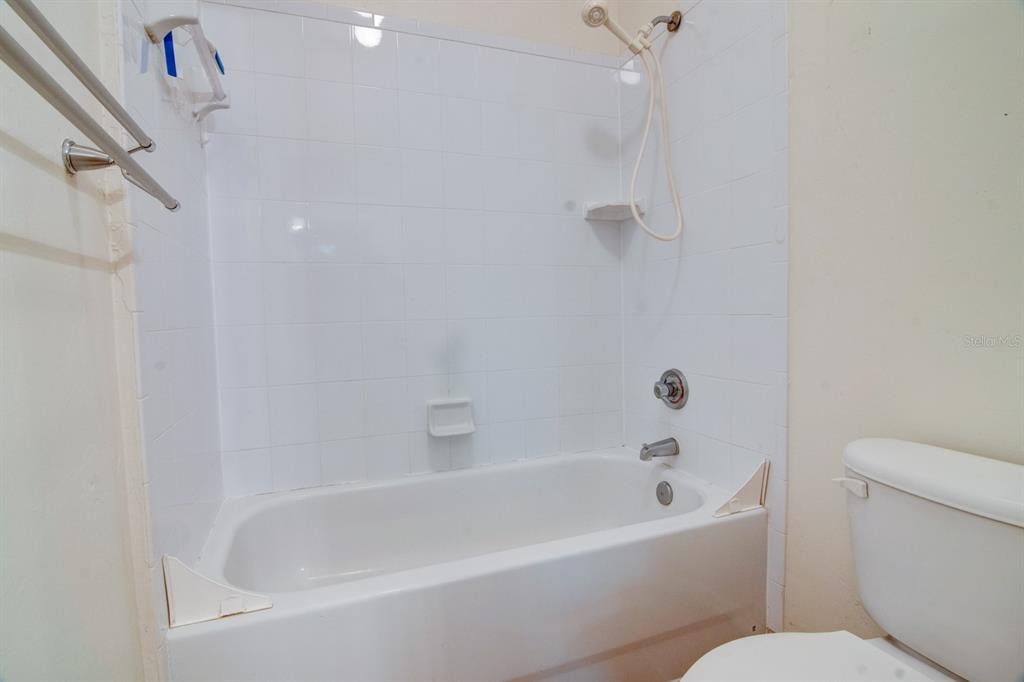 1563 Northwest 29 Road, Unit 108 Gainesville, FL 32605 - Photo 22 of 25 a white bath tub sitting next to a white toilet