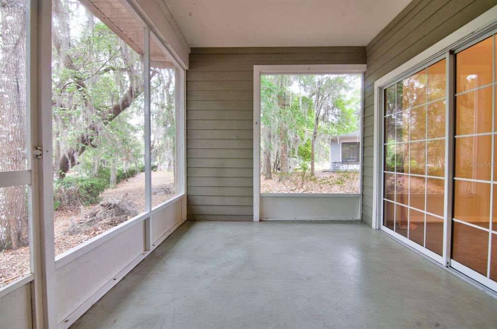 1563 Northwest 29 Road, Unit 108 Gainesville, FL 32605 - Photo 23 of 25 a view of an empty room with wooden floor and a window