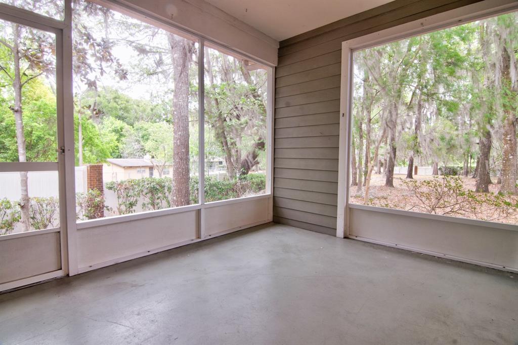 1563 Northwest 29 Road, Unit 108 Gainesville, FL 32605 - Photo 25 of 25 an empty room with large windows and city view