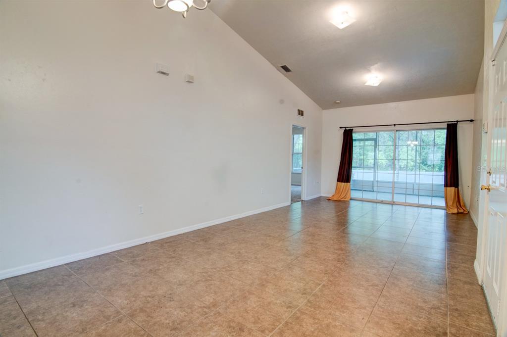 1563 Northwest 29 Road, Unit 108 Gainesville, FL 32605 - Photo 3 of 25 an empty room with wooden floor and windows