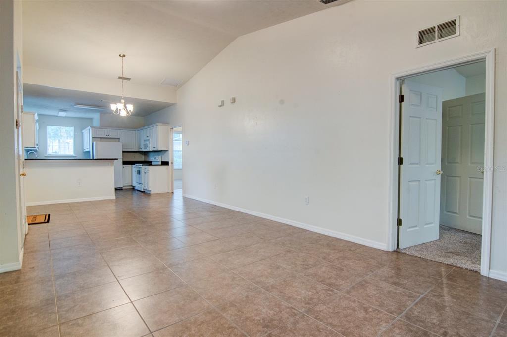 1563 Northwest 29 Road, Unit 108 Gainesville, FL 32605 - Photo 5 of 25 a view of a kitchen with a sink and a refrigerator