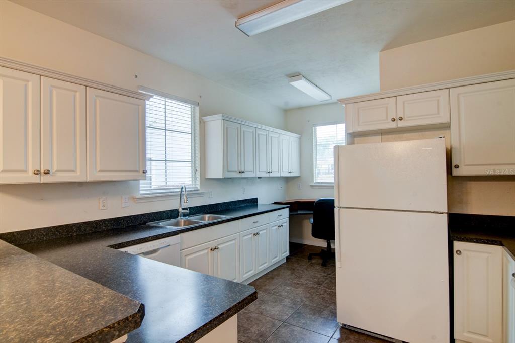 1563 Northwest 29 Road, Unit 108 Gainesville, FL 32605 - Photo 8 of 25 a white refrigerator freezer sitting inside of a kitchen