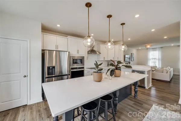 a large kitchen with a table and chairs