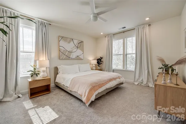 a bedroom with a large bed and a window
