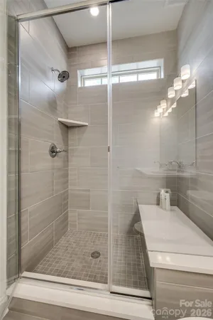 a bathroom with a shower and a sink