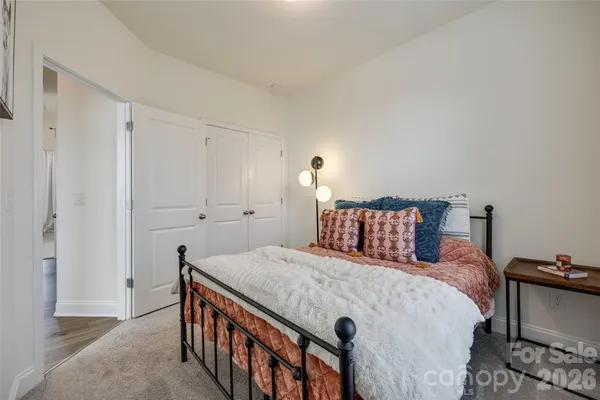 a bedroom with a bed and a night stand